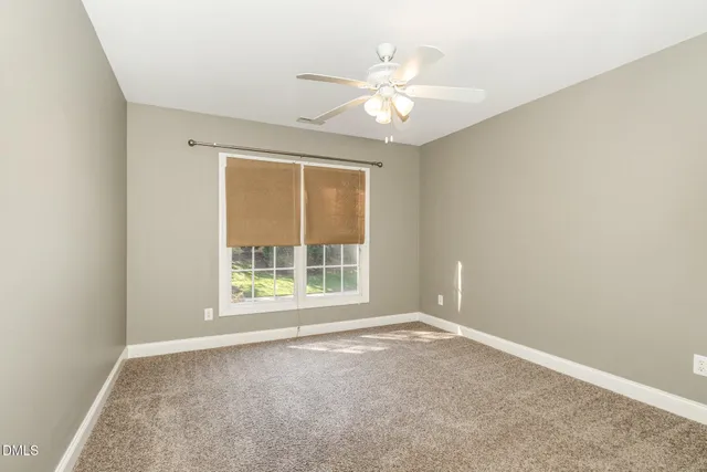 a view of a room with wooden floor and fan