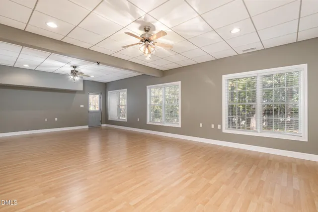 a balcony with wooden floor and trees