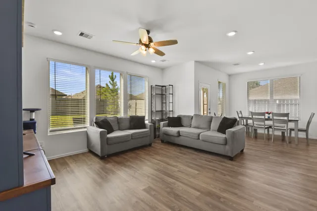 a living room with furniture and a large window