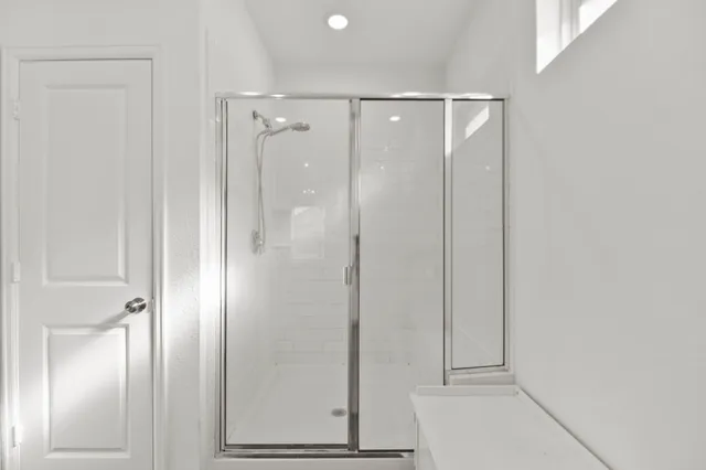 a bathroom with a glass shower door