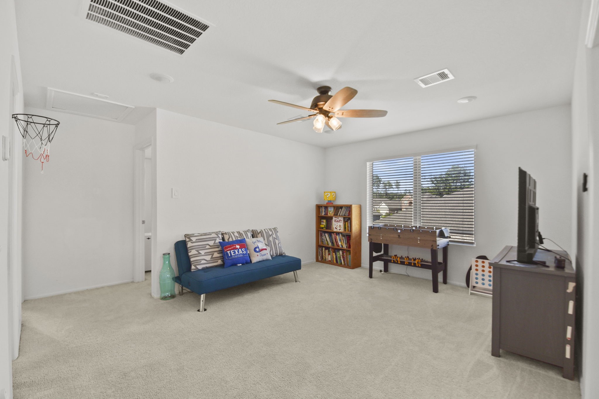 2851 Paradise Ridge Way Conroe, TX 77301 - Photo 20 of 33 a living room with furniture and a flat screen tv