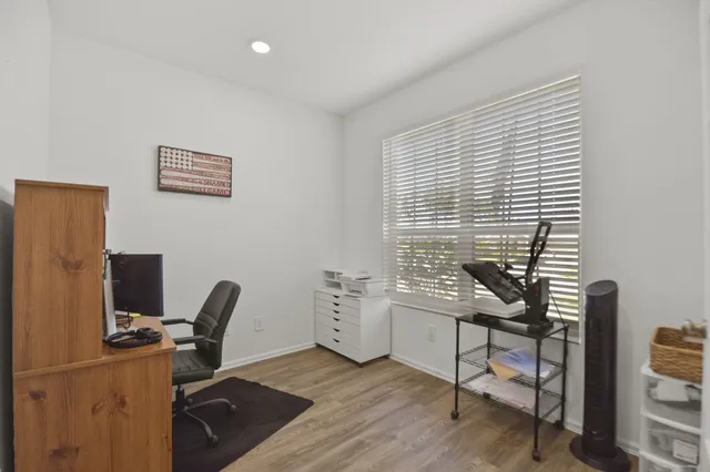 a view of a workspace with furniture and a window