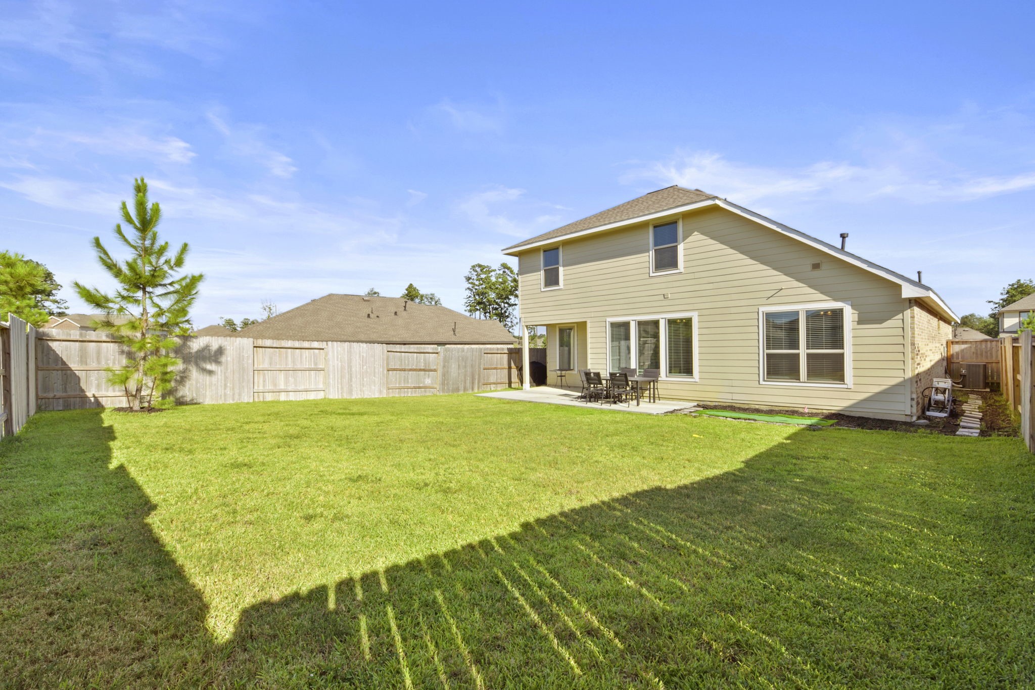 2851 Paradise Ridge Way Conroe, TX 77301 - Photo 31 of 33 a view of a house with a yard
