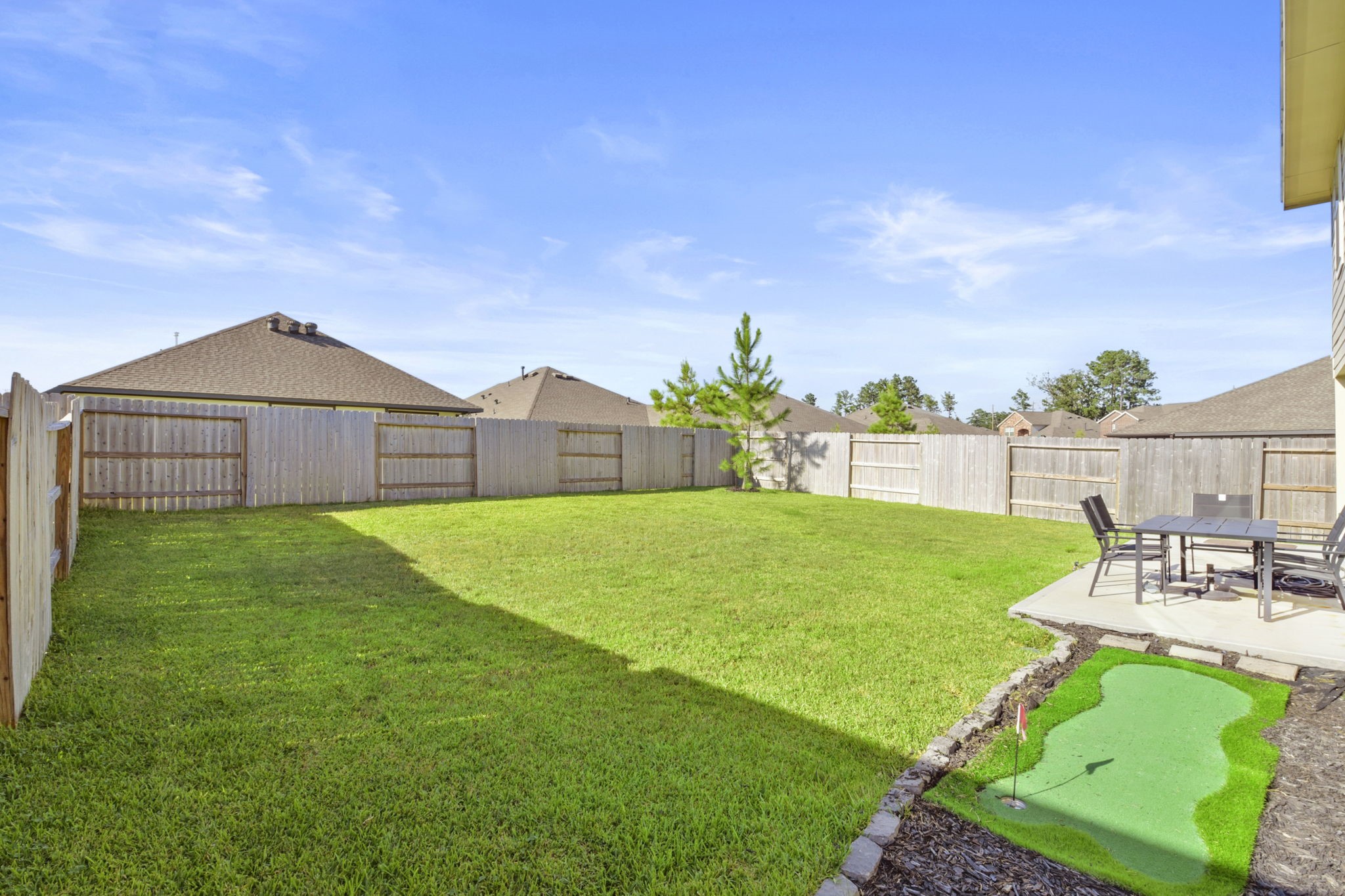 2851 Paradise Ridge Way Conroe, TX 77301 - Photo 32 of 33 a view of a table and chairs in the garden