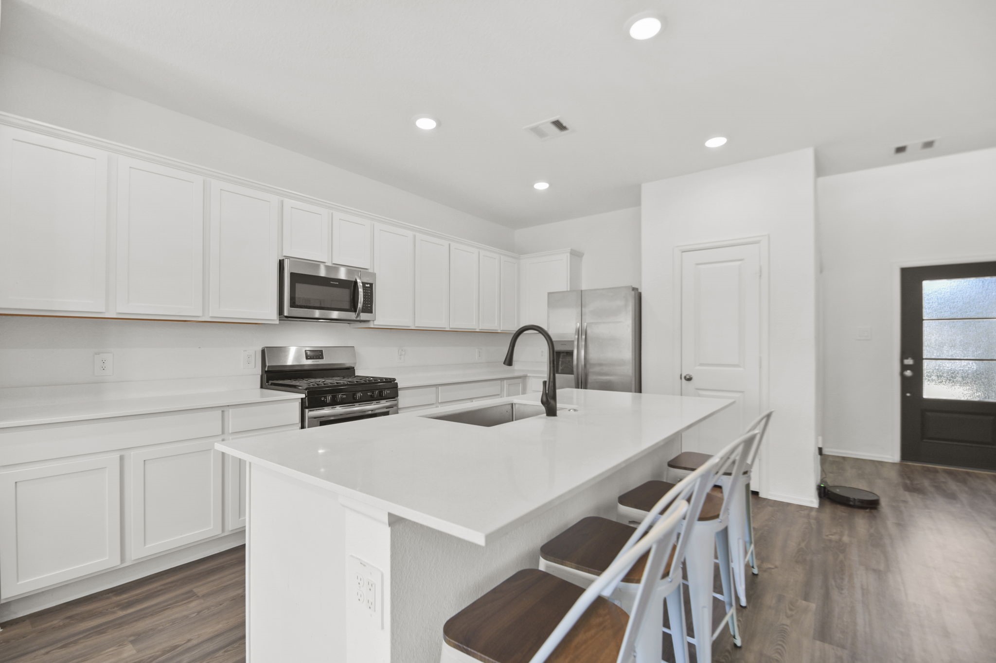 2851 Paradise Ridge Way Conroe, TX 77301 - Photo 6 of 33 a kitchen with stainless steel appliances a stove a sink a microwave a refrigerator and cabinets