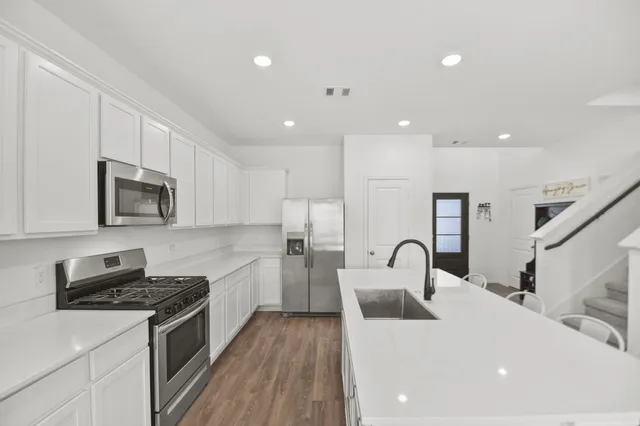 a kitchen with counter top space cabinets and stainless steel appliances