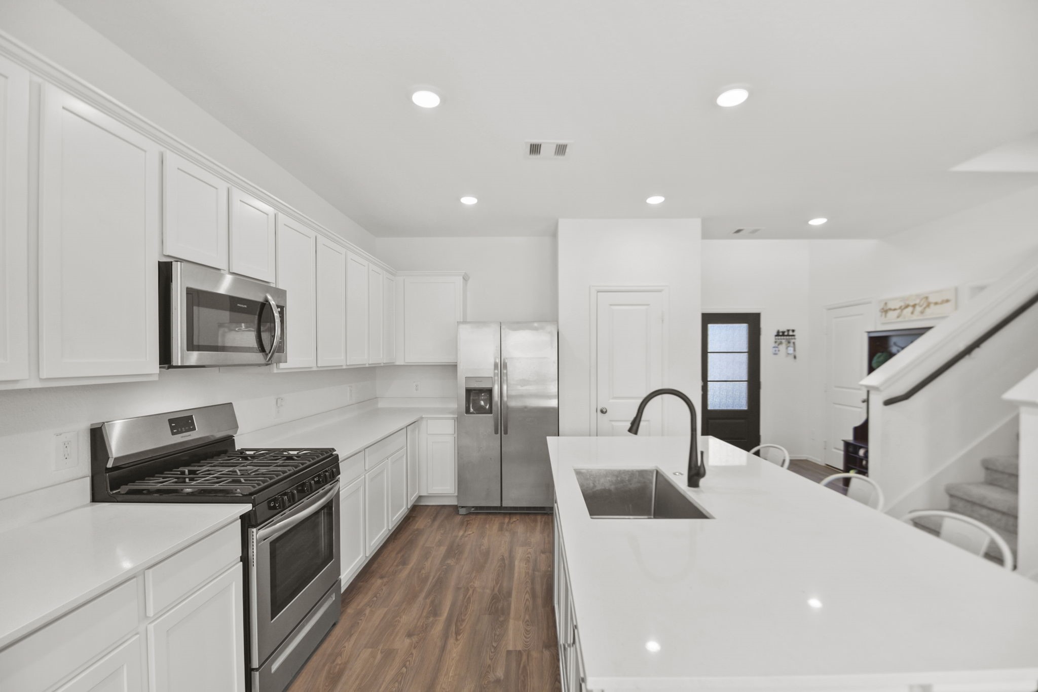 2851 Paradise Ridge Way Conroe, TX 77301 - Photo 8 of 33 a kitchen with counter top space cabinets and stainless steel appliances