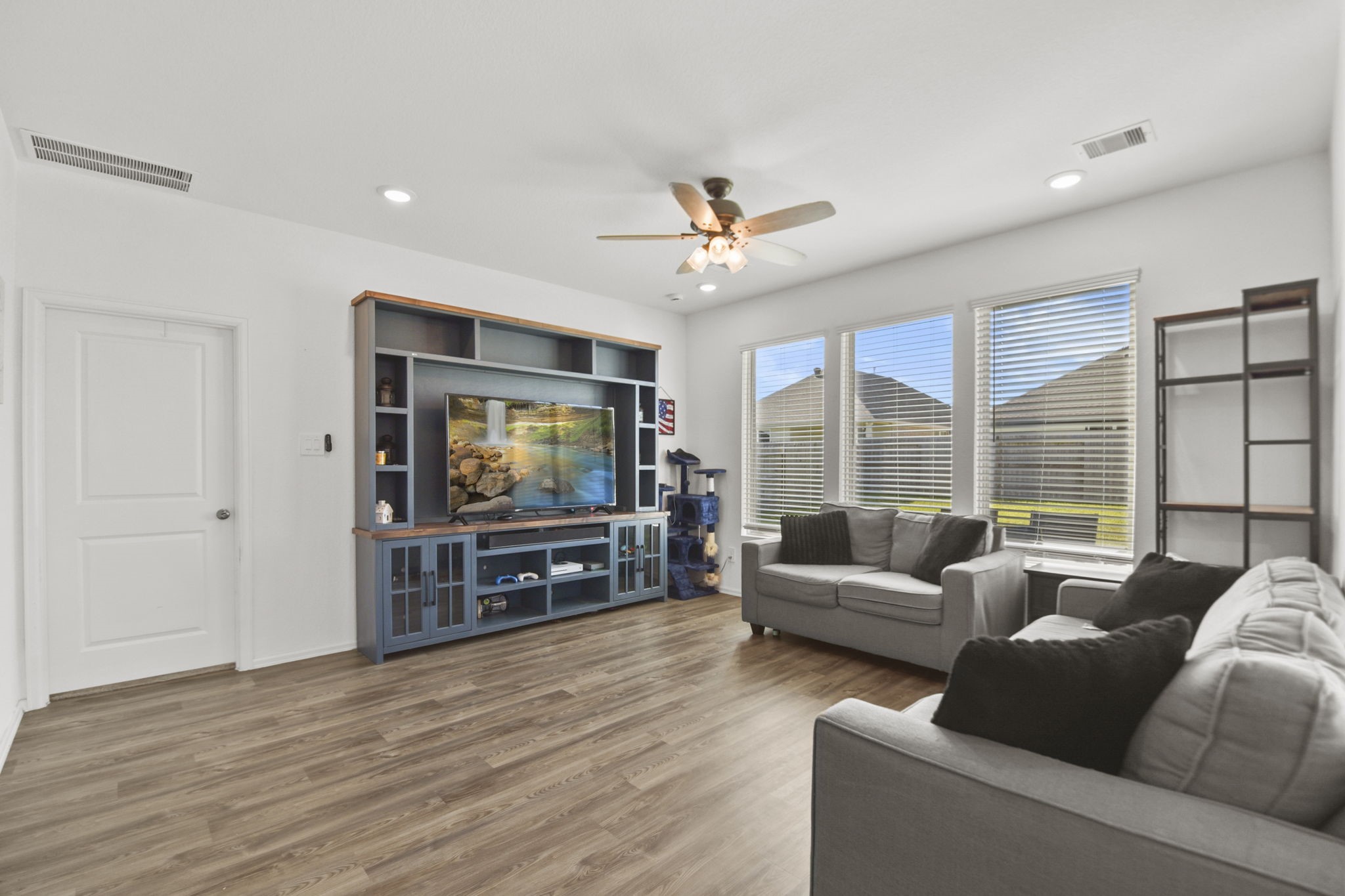 2851 Paradise Ridge Way Conroe, TX 77301 - Photo 10 of 33 a living room with furniture and a flat screen tv