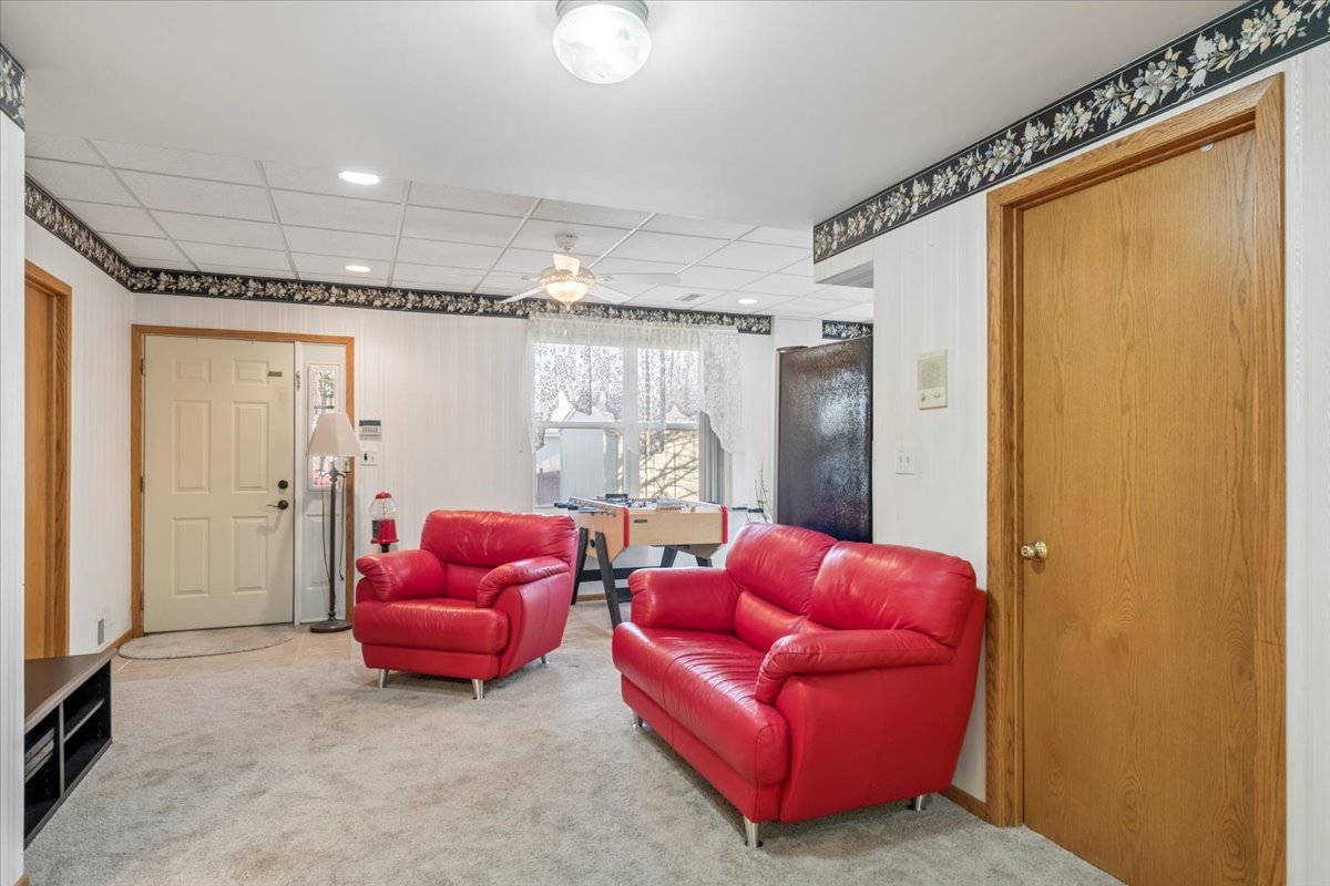 821 Red Barn Lane Elgin, IL 60124 - Photo 16 of 27 a living room with furniture a ceiling fan and a window