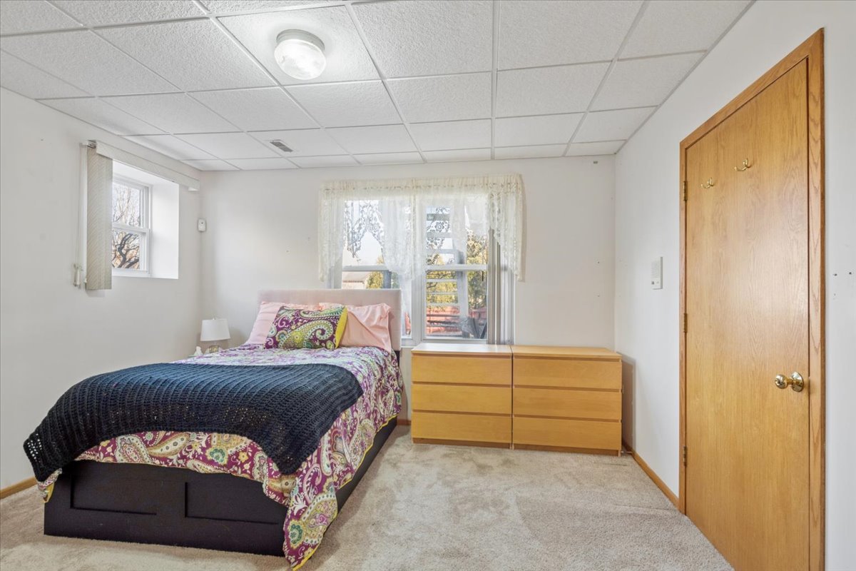 821 Red Barn Lane Elgin, IL 60124 - Photo 18 of 27 a bedroom with a bed and a window