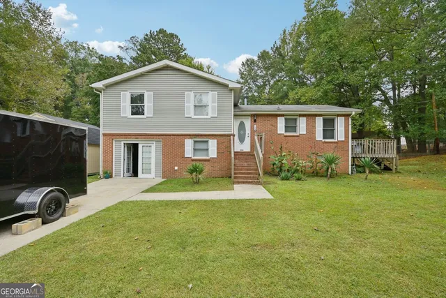 a front view of house with a garden and patio