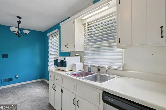 a kitchen with a sink and cabinets
