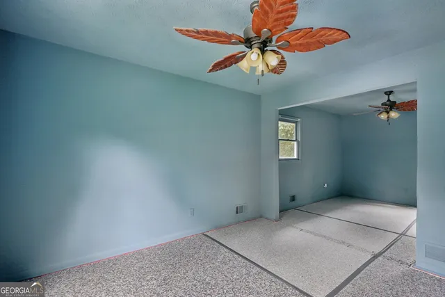 an empty room with a fan