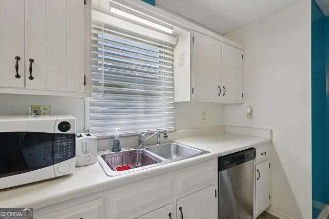 a kitchen with a sink and cabinets