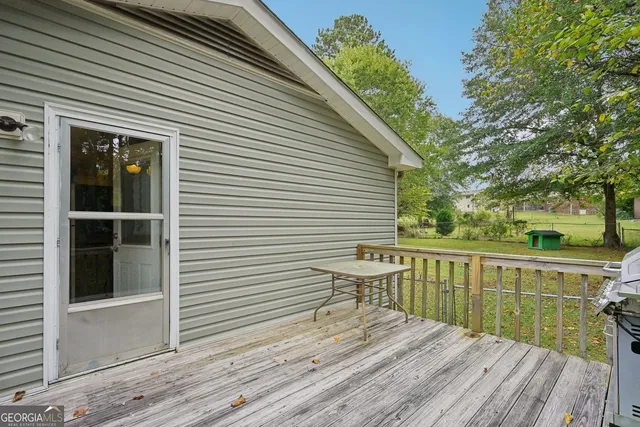 a view of a deck with chair and wooden floor