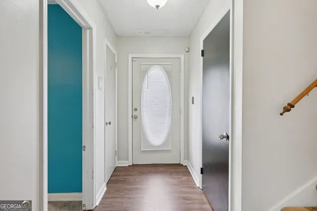 a view of a room with an entryway door
