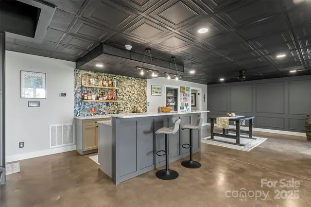 a living room with lots of furniture and a chandelier
