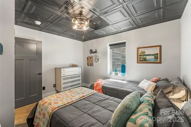 a bedroom with a bed and a chandelier