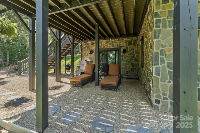 a view of backyard with plants and outdoor seating