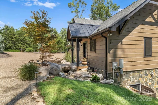 an aerial view of a house with a yard and lake view