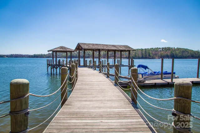 a view of a patio with table and chairs potted plants with large tree