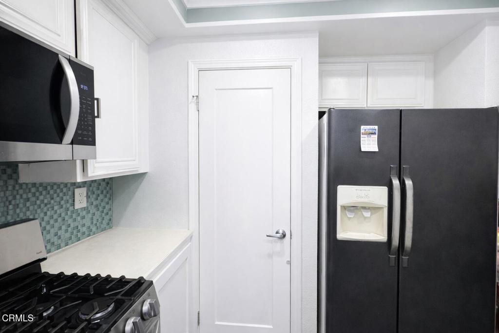 1440 Nelson Place Oxnard, CA 93033 - Photo 4 of 7 a kitchen with a refrigerator and a stove