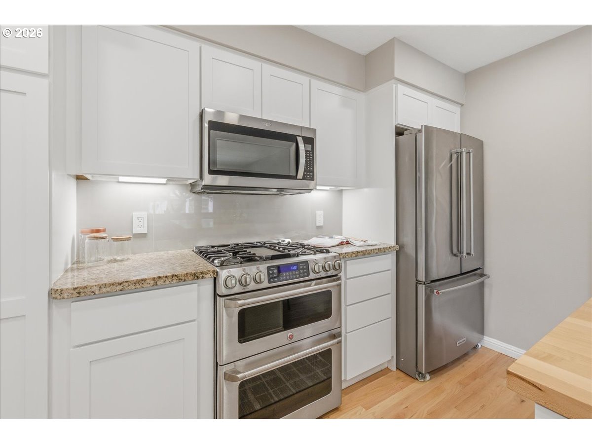 3130 Southwest 116th Avenue Beaverton, OR 97005 - Photo 15 of 44 a kitchen with a stove microwave and refrigerator