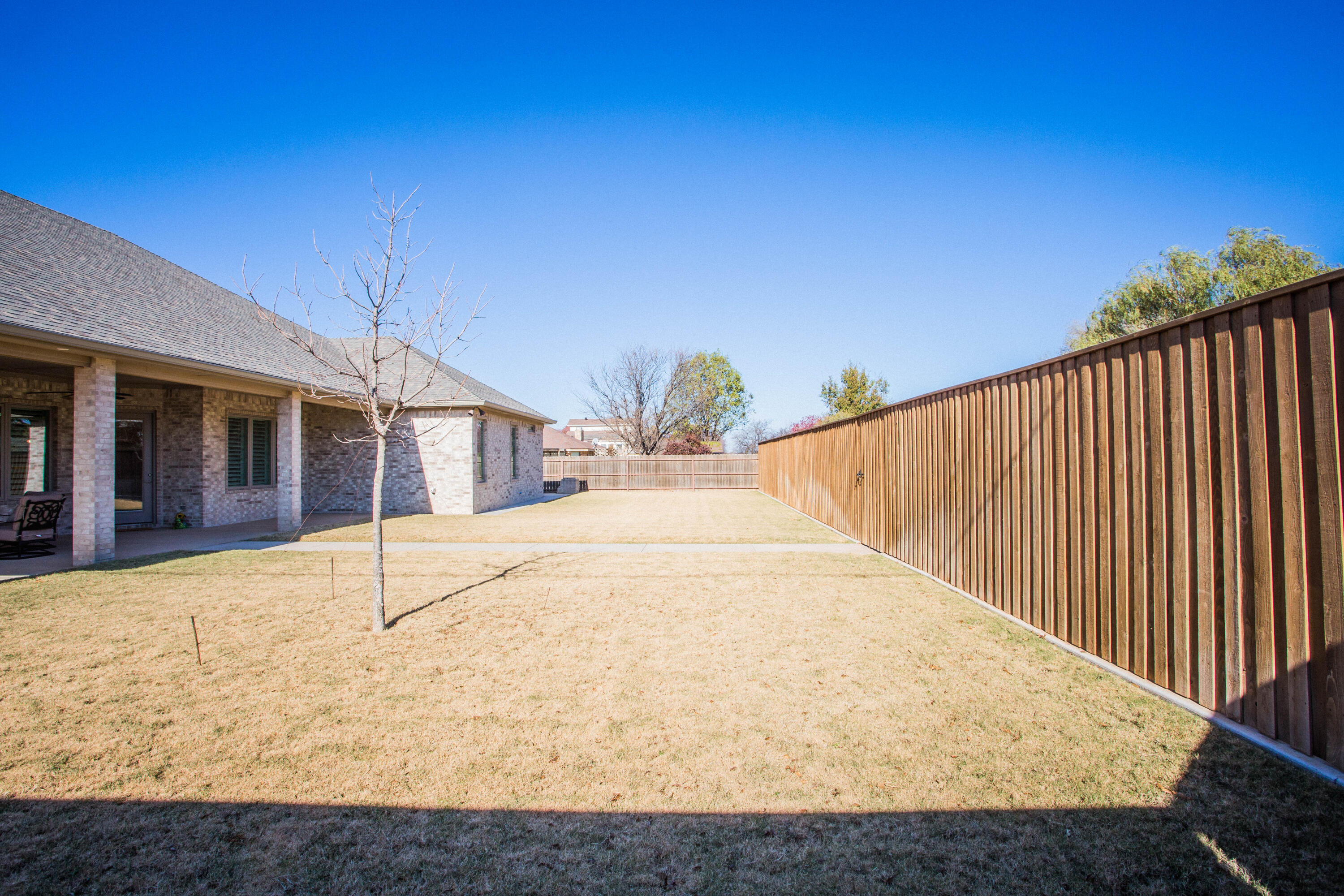 209 South Holliday Plainview, TX 79072 - Photo 25 of 29 a white house with a tree in front of it