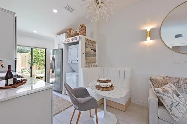a view of a dining room with furniture and a chandelier