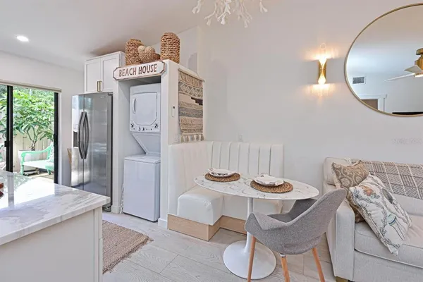 a view of a dining room with furniture and a chandelier