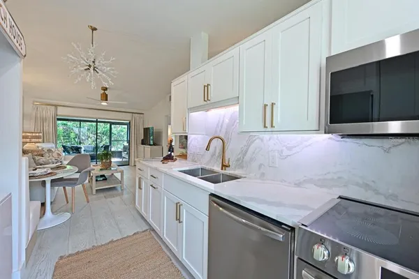 a kitchen with a sink stove and cabinets
