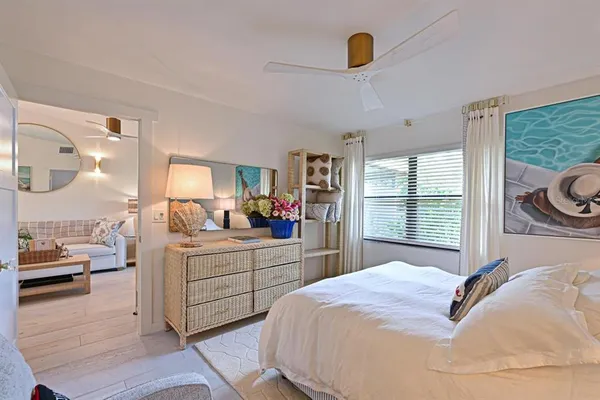 a bedroom with a bed and a large window with outer view