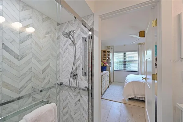 a view of a bedroom with a bed and a window