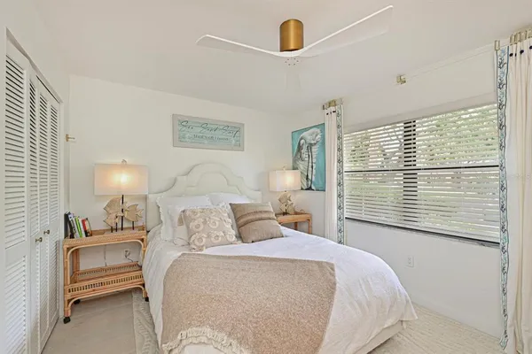 a bedroom with a bed and a night stand