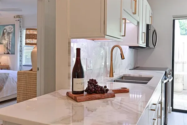 a view of living room with furniture and kitchen area