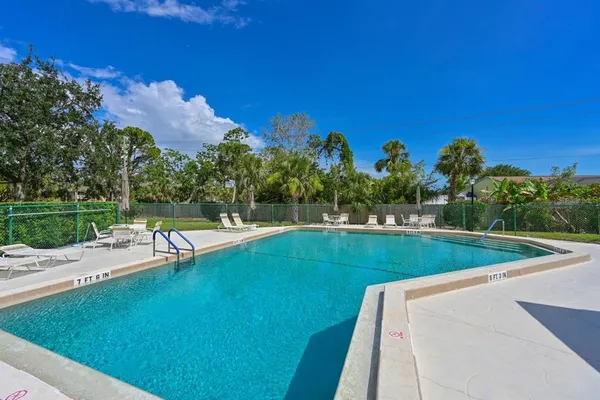 a view of a swimming pool with a yard
