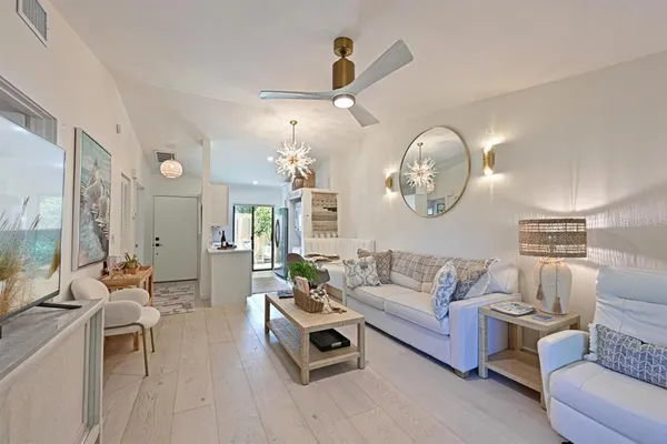 a living room with furniture and a chandelier