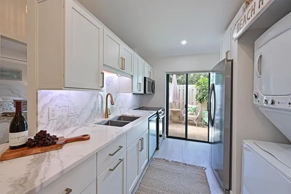 a kitchen with stainless steel appliances a sink stove and cabinets