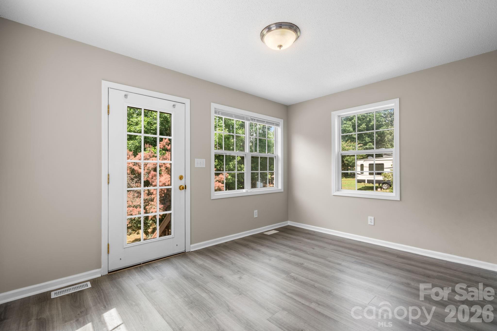 4967 Addison Lane Hickory, NC 28601 - Photo 12 of 43 an empty room with wooden floor and windows
