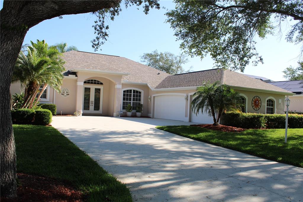 11257 28th St Circle East Parrish, FL 34219 - Photo 42 of 59 a view of a white house with a yard plants and palm trees