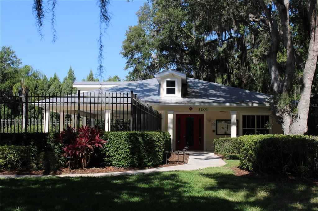11257 28th St Circle East Parrish, FL 34219 - Photo 45 of 59 a view of a house with brick walls and a yard with plants