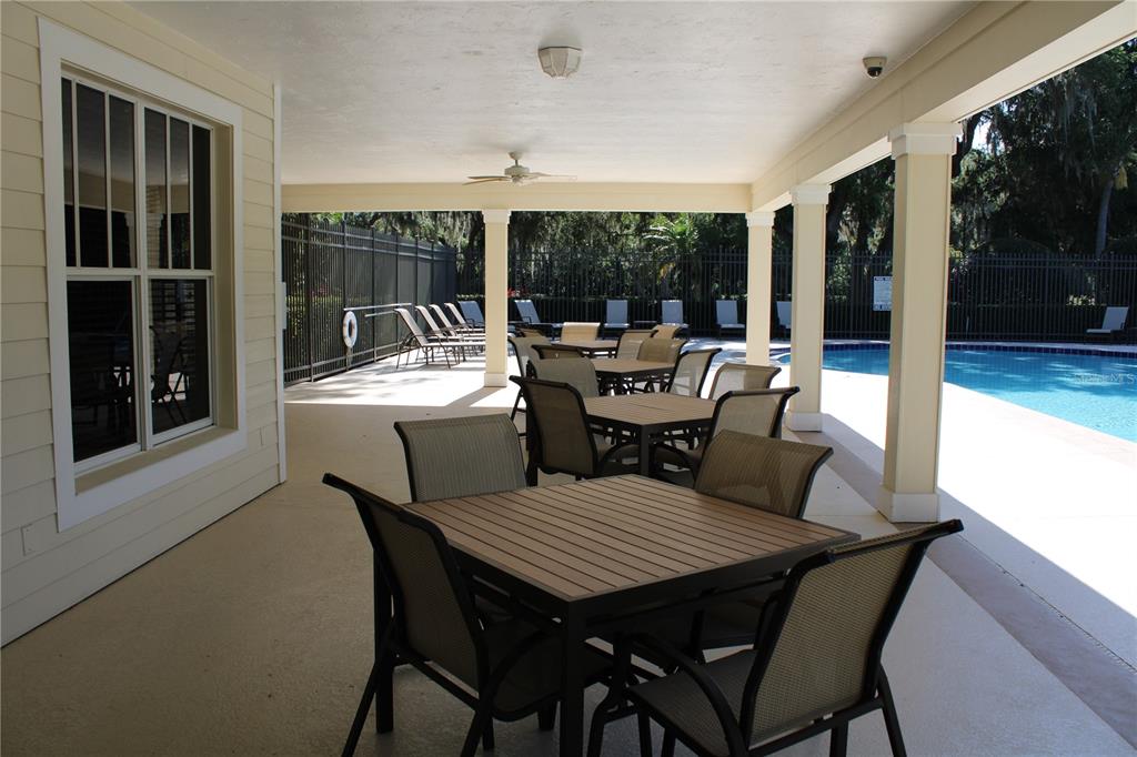 11257 28th St Circle East Parrish, FL 34219 - Photo 51 of 59 a view of a dining room with furniture large windows and wooden floor