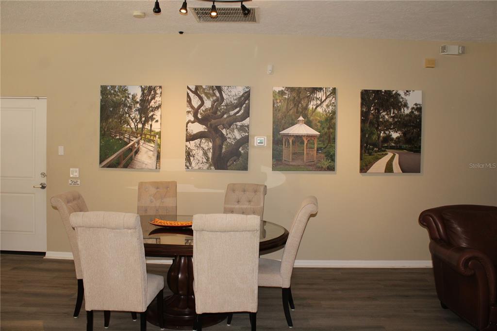 11257 28th St Circle East Parrish, FL 34219 - Photo 55 of 59 a view of a dining room with furniture and wooden floor
