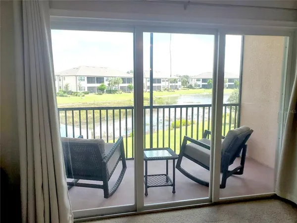 a living room with furniture and a floor to ceiling window