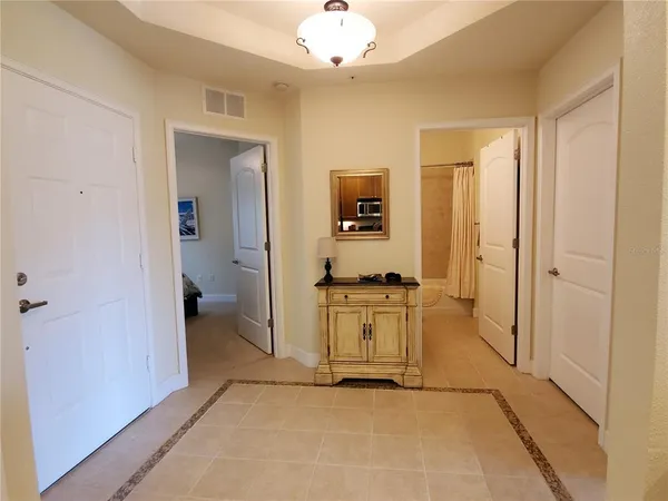 a view of a hallway with a livingroom and a bathroom