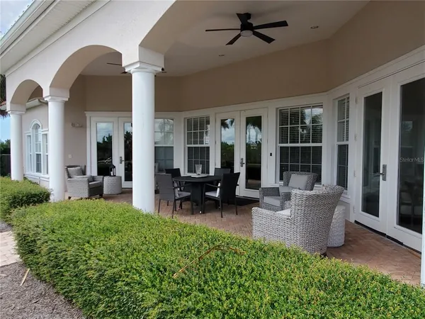a view of a house with furniture and garden