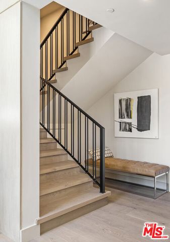 a view of a hallway with furniture and windows