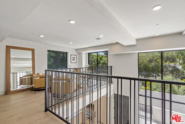 a living room with furniture and large windows