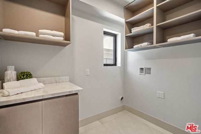 a spacious bedroom with a bed and a window