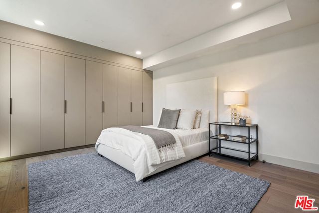 a bedroom with a bed and a painting on the wall